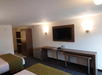 Enjoy comfort and convenience with two queen beds, a desk for work, and a TV for entertainment.