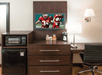 Microwave, mini-refrigerator, flat-screen TV, desk, and chair inside a non-smoking guest room.