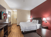 One king bed and a flat-screen TV inside a non-smoking guest room.