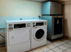Guest laundry area complete with a coin-operated washing machine and dryer. Ice machine is also available for guest use.