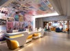 Stylish front desk and lobby with seating area.