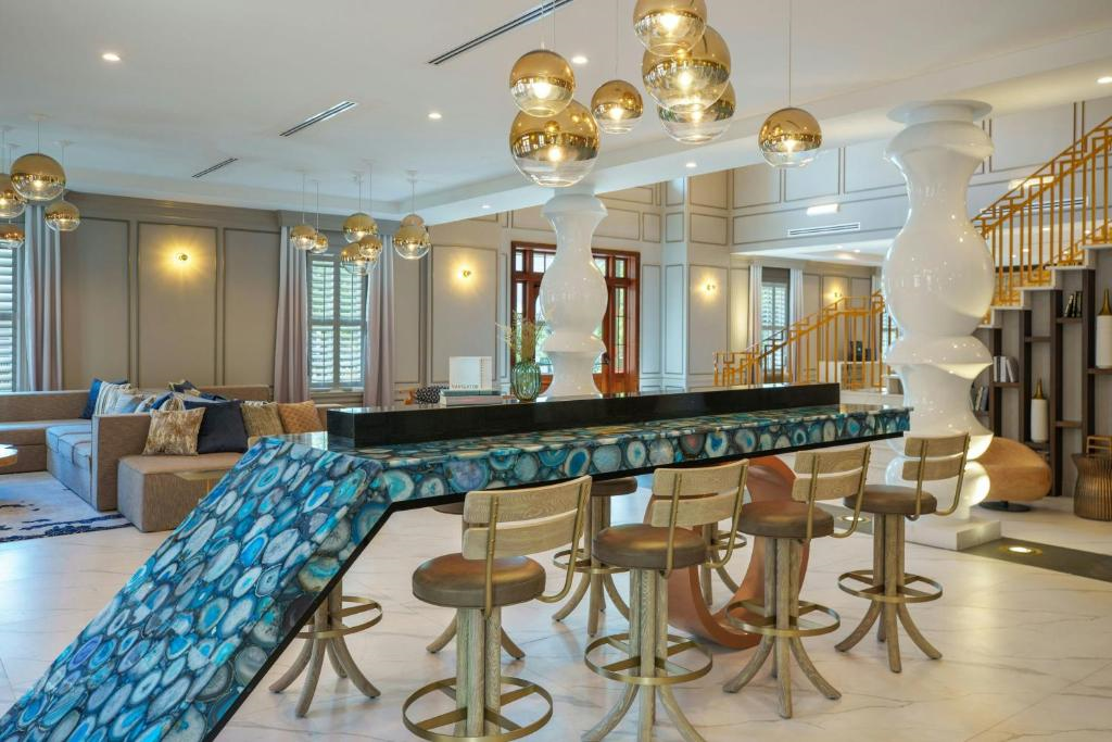 Stylish lobby with a blue gemstone-inspired bar, warm lighting, and seating area.