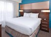 One king bed with plush bedding inside a non-smoking room.