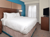 One king bed with plush bedding and a flat-screen TV inside a non-smoking room.