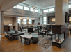 A lounge area with a few different seating options and several windows letting light in at the Residence Inn by Marriott Columbus Airport.