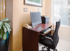 Business center with ergonomic chair, desk, and computer.