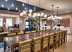Common area with a long table, chairs and sofas.