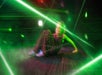 A young girl in climbing over and under green laser at Ripleys Super Fun Park.