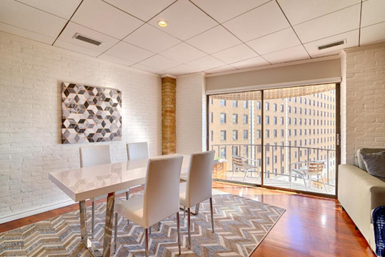 In-room dining table and a floor-to-ceiling windows inside a guest room.