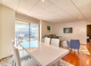 In-room dining table and a floor-to-ceiling windows inside a guest room.