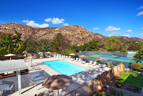 Riviera Oaks Resort's outdoor pool and tennis courts with a gorgeous view of the valley/hills.