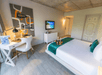 Guest room with 1 king bed, flat-screen TV and work desk at Riviera Suites, FL.
