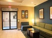 Lobby area with seating, artwork, and a sign for Conference Rooms & Sales Office.
