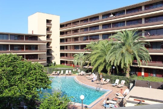 Outdoor pool with plenty of lounge chairs.