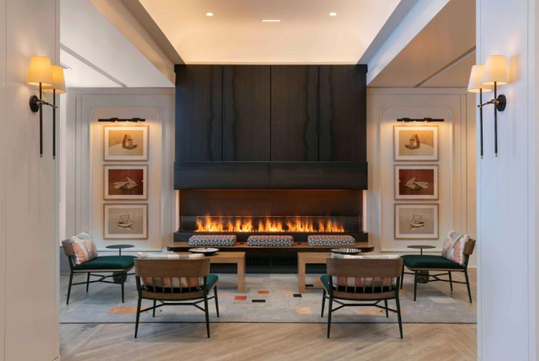 Beautifully decorated common area with a sofa and fireplace.