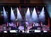 The Six Brothers appear to be performing a tribute song for American soldiers, accompanied by a picture of American soldiers on a plane displayed on an LED screen in the background.