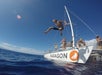 Guest jumping off the bow of the Paragon catamaran into the ocean.