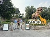 Three gentlemen cutting the ribbon at the entrance as they open Dino Adventure Park.