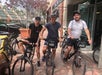 Three men taking photos with the Unlimited Biking bikes they rented