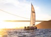 The Adventure Cat sailing catamaran at sunset with the Golden Gate Bridge