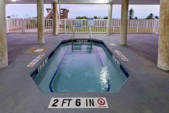Indoor pool area with a narrow, rectangular pool labeled "2 FT 6 IN". Surrounding are warning signs and a "No Diving Allowed" notice.