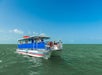 Fury Water Adventures' Island Cat boat cruising on the water with passengers enjoying a sunny day in St. Augustine, Florida.