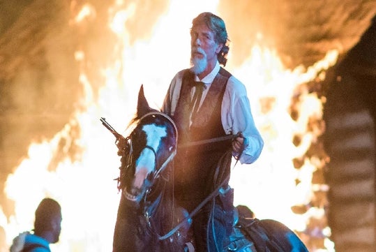 Jim Lane riding a horse with a fire behind him at Shepherd of the Hills Outdoor Drama in Branson, Missouri.