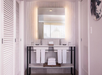Private bathroom with two sinks, mirror, and fresh towels.