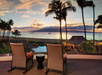 Outdoor lobby with chairs and captivating views of the pool and beach.