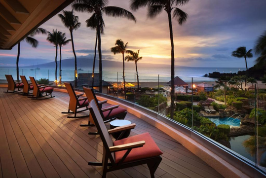 Outdoor lobby with chairs and captivating views of the pool and beach.