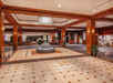 Spacious hotel lobby at Sheraton Music City Hotel with wood accents, chandelier, marble flooring, and central seating area.