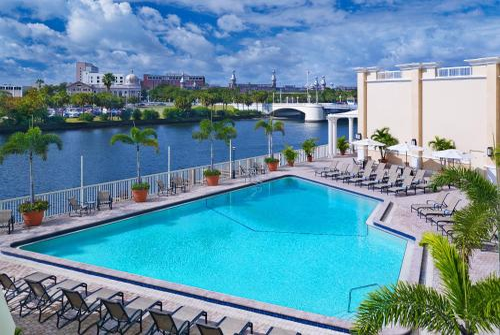 Outdoor pool with sun loungers.