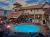 The outdoor pool, lined with sun loungers, offers a perfect setting for swimming and soaking up the sun.