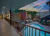 The outdoor corridor offers a view of the pool, adding a refreshing touch to every walk.