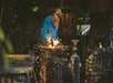 A black smith working with sparks flying around him at Silver Dollar City in Branson, Missouri.