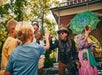 A young boy and his family giving a cast member a high five at Silver Dollar City in Branson, Missouri.