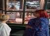 A tour guide sharing a story with a guest at the New Orleans Pharmacy Museum.