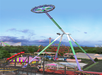 A large amusement park ride swings in the air, with other rides and attractions visible in the background, surrounded by trees.
