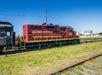 A train with a red engine car with "California Western" on the side of it on a sunny day with Skunk Train in San Francisco, California, USA.