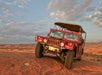 The tour guests taking in the sights in the Hummer from the top of one of the petrified sand dunes on the Slickrock Safari Hummer Adventure Tour in Moab Utah.