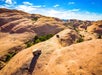 An ariel view of the Hummers going across the dunes and a beautiful view of the landscape on the Slickrock Safari Hummer Adventure Tour in Moab Utah.