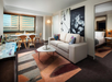 Enjoy a balanced blend of comfort and functionality with a sofa and dining table in your living area.