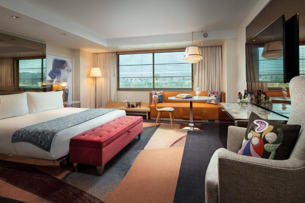Unwind in comfort with a king bed and a cozy seating area, perfect for relaxing.