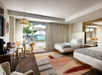 Perfect for family or friends, this room features two queen beds, a table for two, and a TV for relaxing.