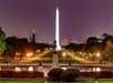 Washington Monument glowing above the National Mall after dark.