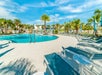 The pool area has plenty of lounge chairs for guests to enjoy the sunshine.