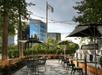 Terrace/patio with seating area surrounded with trees.