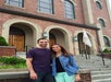 A couple posing in front of a building on the Sopranos Sites Tour and smiling in New York City, New York, USA.