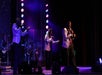 Three men in silver suit jackets singing on a dark purple stage at Soul of Motown in Pigeon Forge, Tennessee, USA.