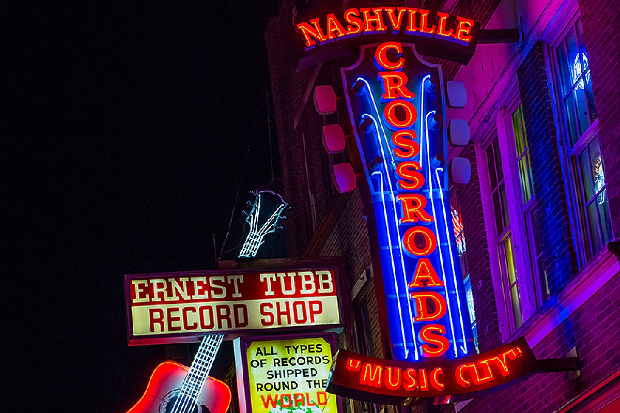 Iconic neon signs illuminating Nashville's famous Broadway.